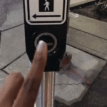 Hand pushing ped signal button