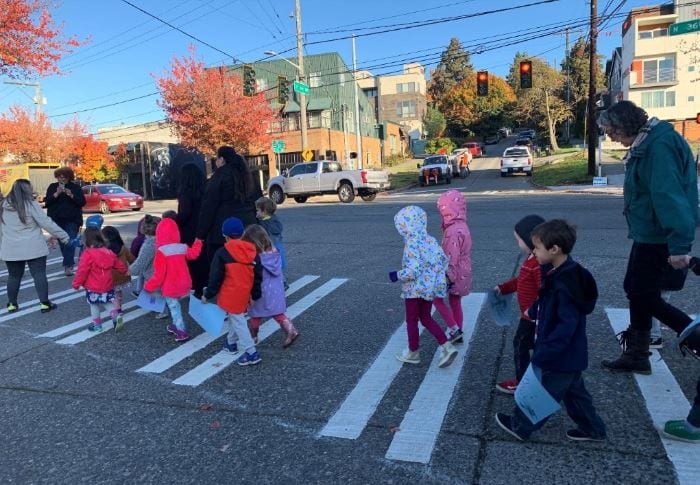 Preschool children using a brand new traffic signal in Fremont.