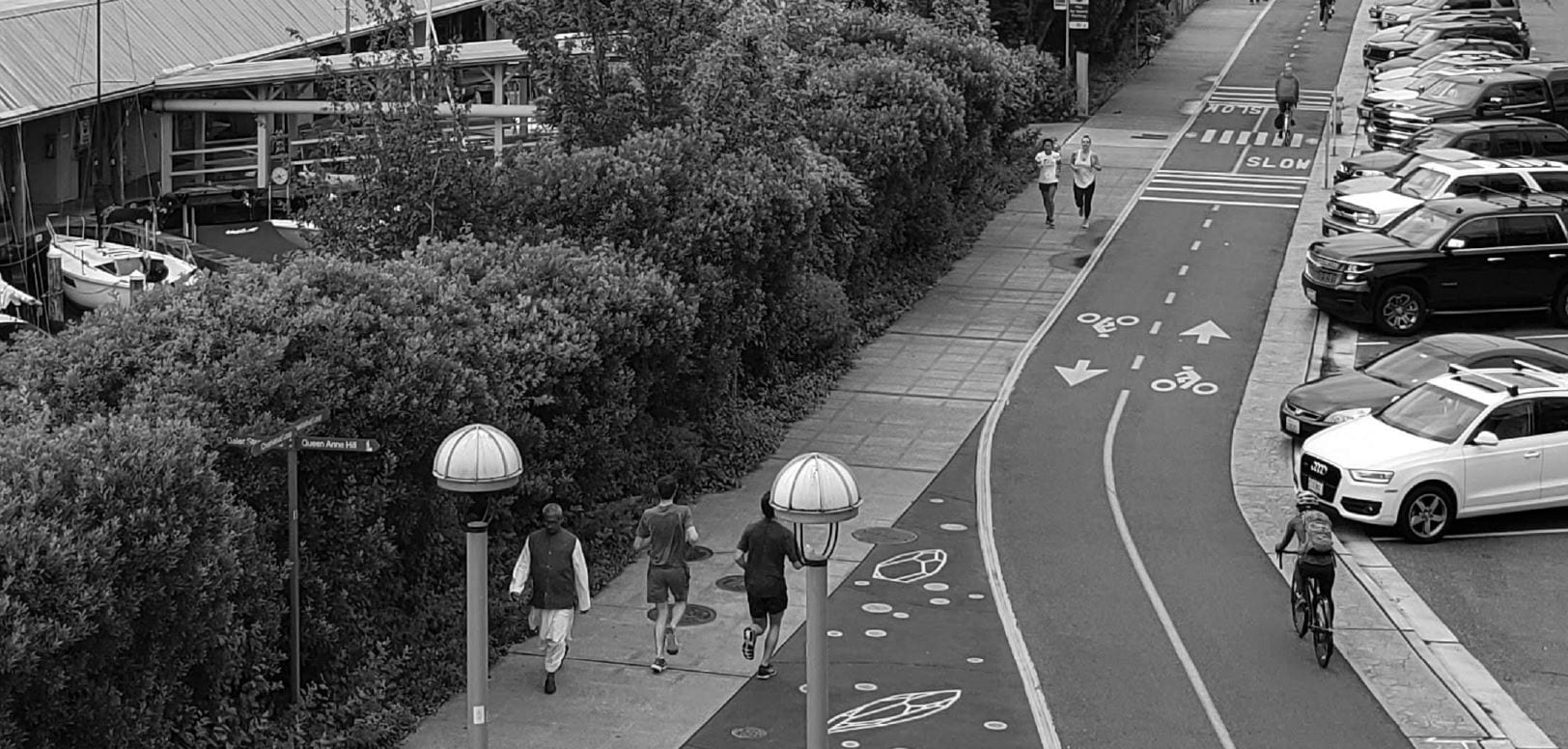 Pedestrians and bikers using protected sidewalks and bike lanes.
