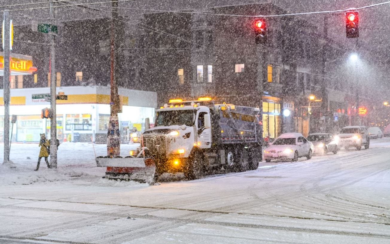 Snowplow and cars on Capitol Hill from 2019 snow. Photo by Tim Durkan