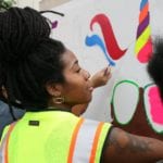 Community member creates safety awareness artwork in Rainier Beach.