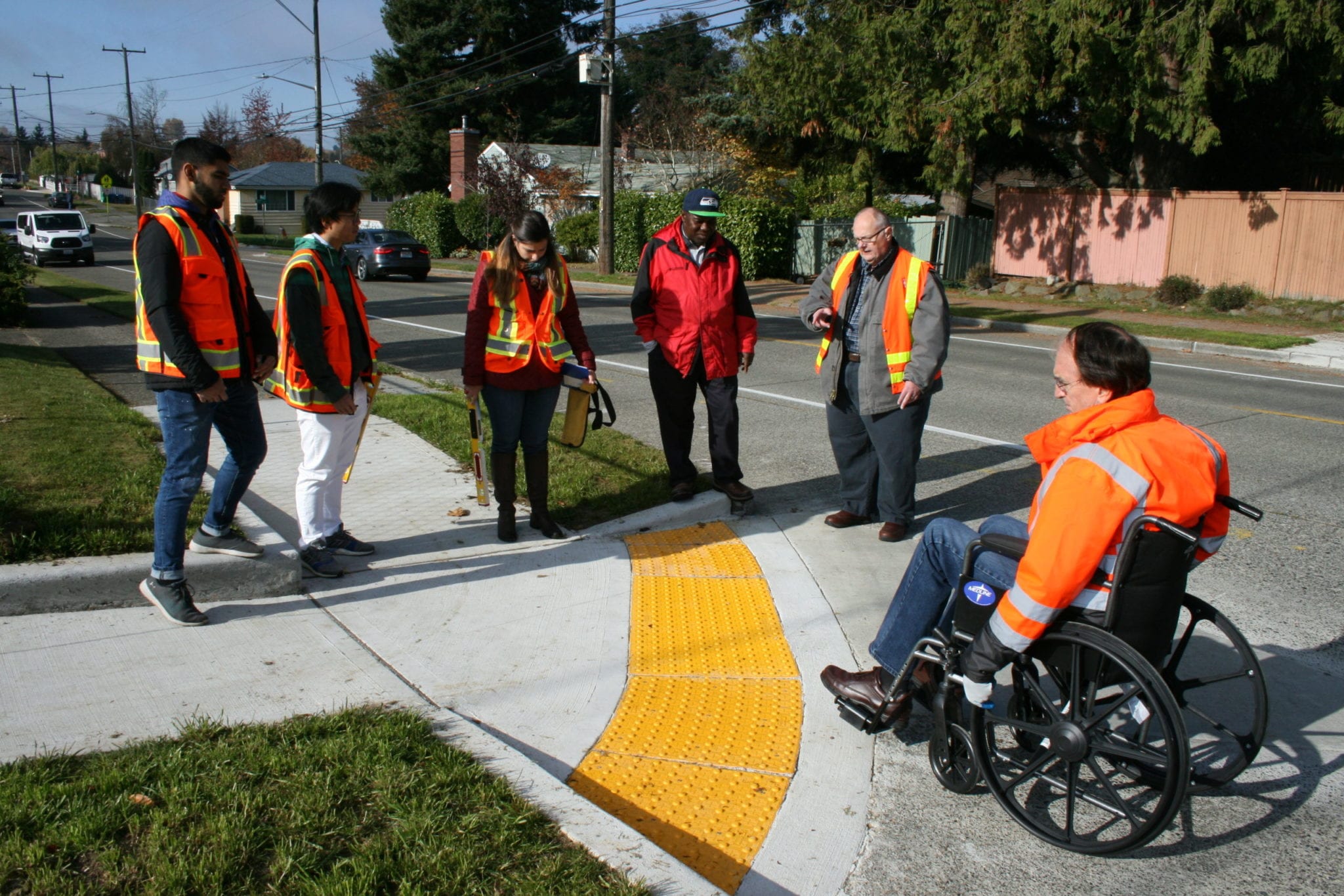 Road engineers using a wheel chair to get onto the sidewalk.