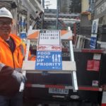SDOT crews bringing out the new Food Pick-up Priority signs.