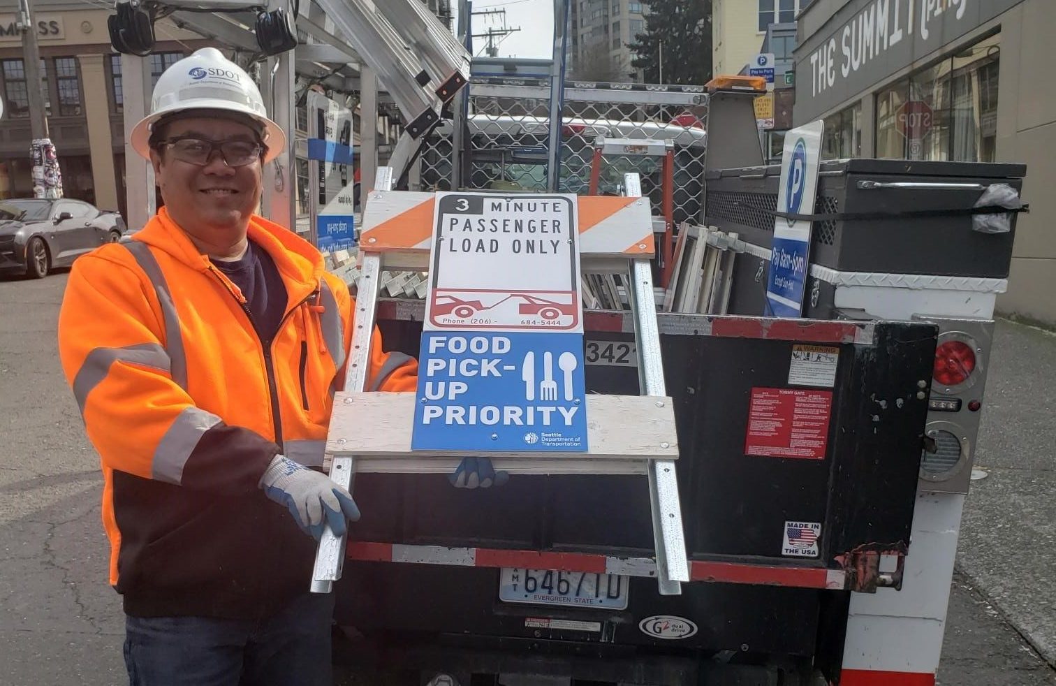 SDOT crews bringing out the new Food Pick-up Priority signs.