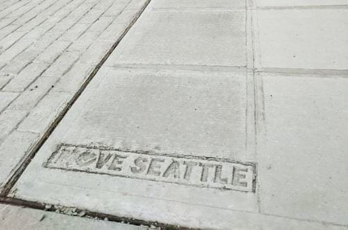 Move Seattle stamped in concrete sidewalk