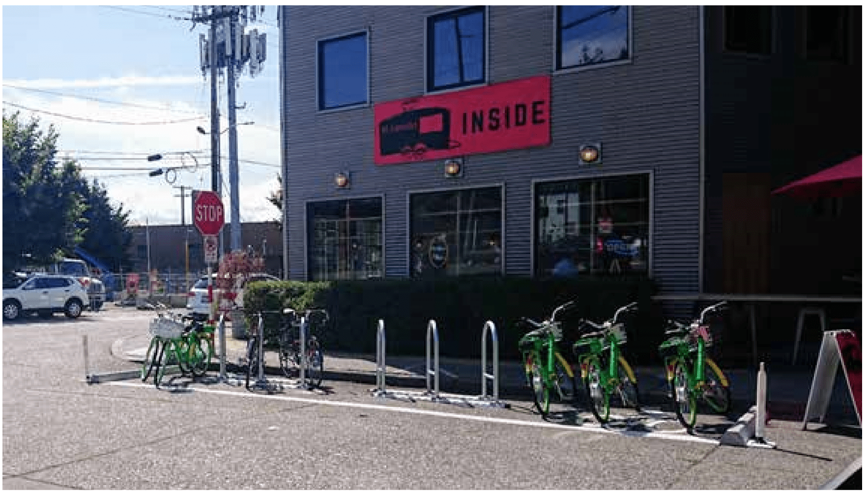 A bunch of Lime bikes parked in a Ballard bike rack. 