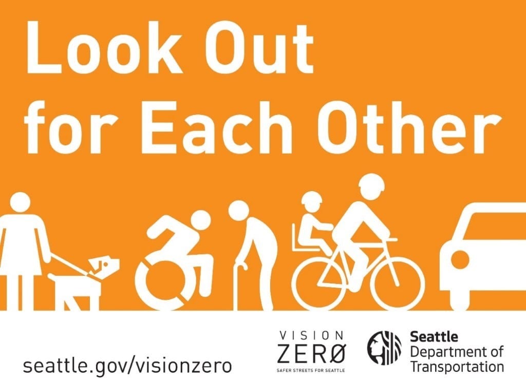 A "Look Out for Each Other" vision zero sign.