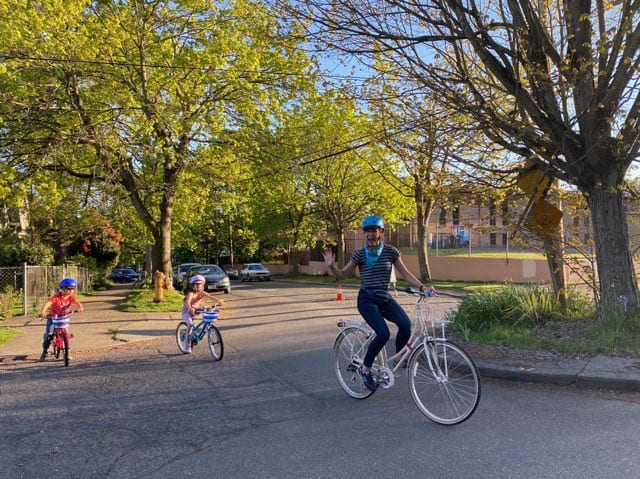 Family riding bikes on a Stay Healthy Street in the Central District