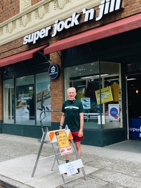 Photo of Super Jock 'n Jill owner in front of store. 