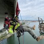 Crew suspended by ropes, drilling into the West Seattle Bridge to collect samples of the concrete to test for corrosion.