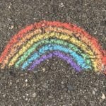 Rainbow chalk artwork on the sidewalk.