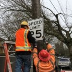 SDOT Crews installing a 25 miles per hour sign.