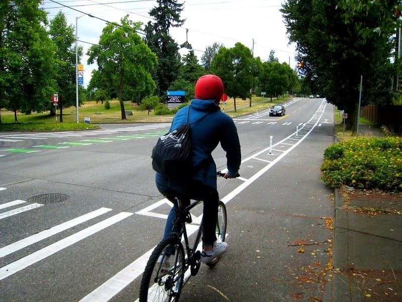 Person riding their bike in a protected bike lane