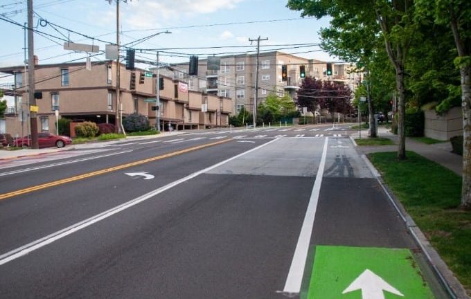 A picture showcasing the changes on Avalon Way SW with newly painted lines on the street and a green bike lane.
