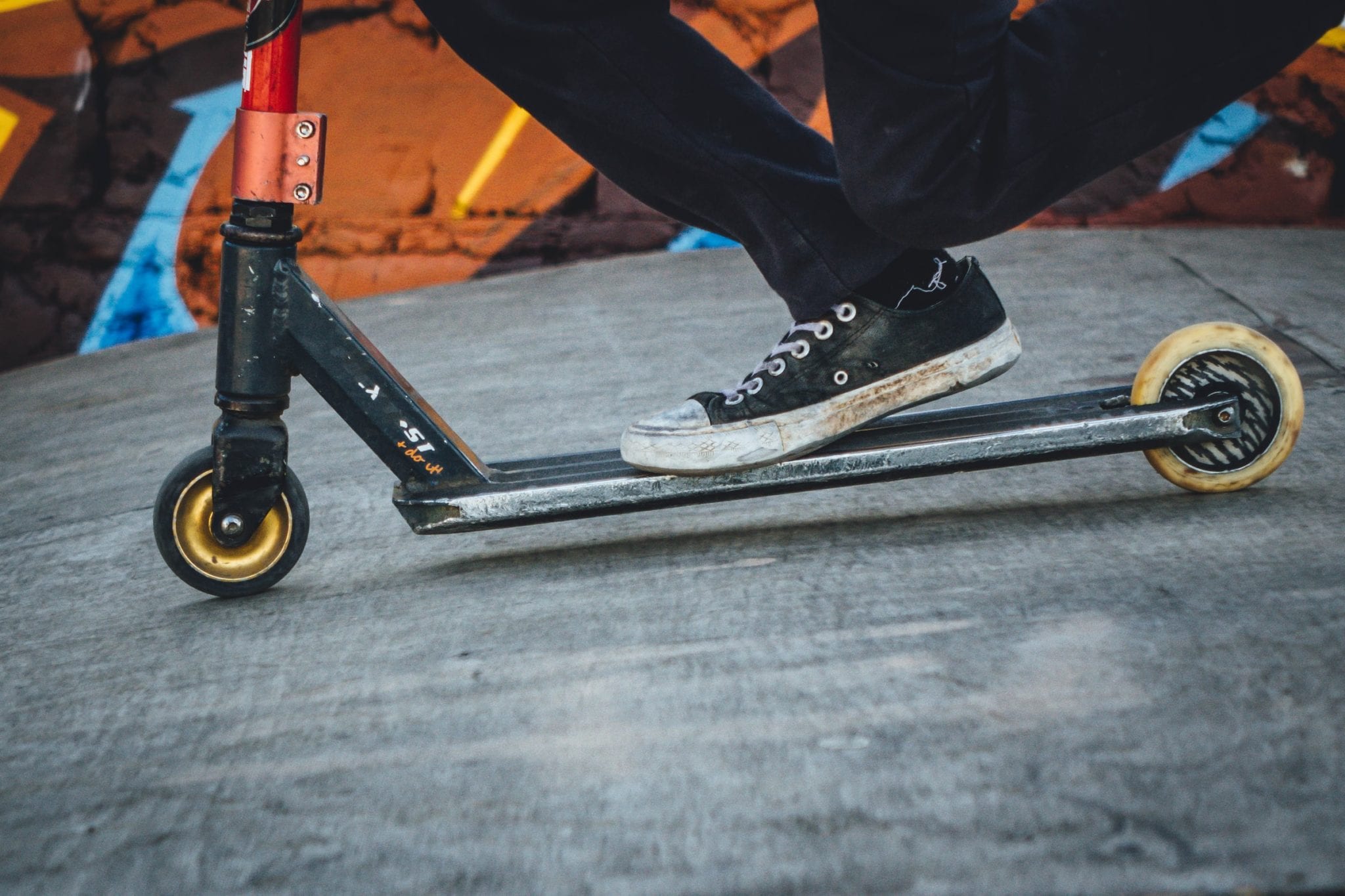 A photo of a person riding on a scooter. Photo by MusicFox Fx on Unsplash