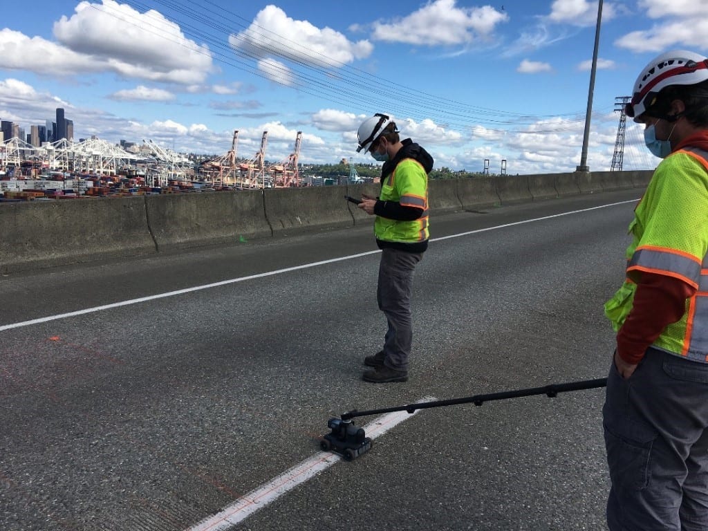 An SDOT crewmember standing on the West Seattle Bridge.