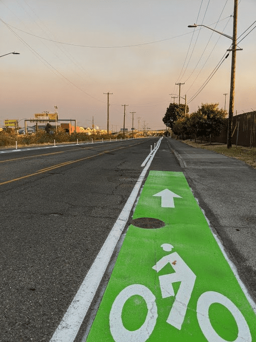 Street level view of East Marginal Way S, showing green painted area of bike lane.