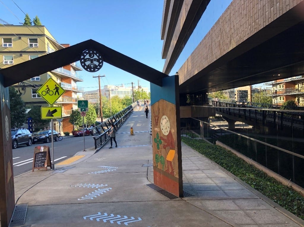 Street-level view of the entrance to the Thomas St. Overpass. Entrance includes a colorful mural.