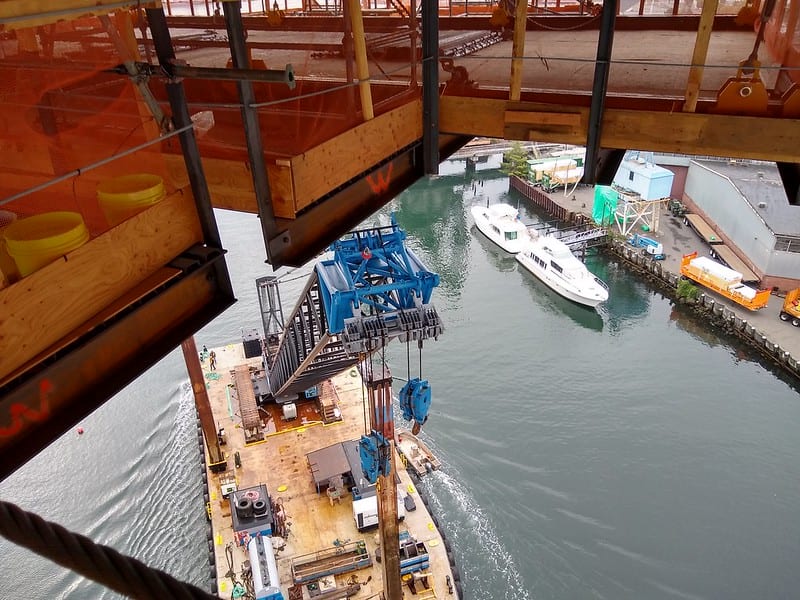 View from above: A crane barge passes beneath the work platform suspended from the West Seattle High-Rise Bridge. 
