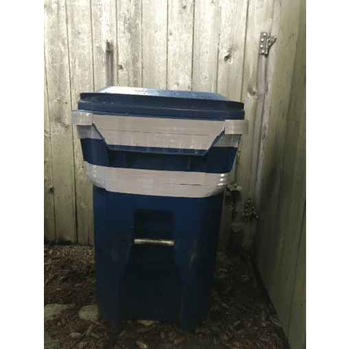 Blue recycling bin shown with reflective tape wrapped in two bands.
