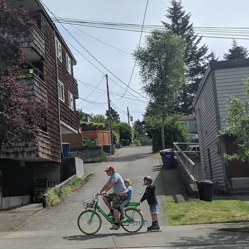 A family bike ride. One person is roller-blading.