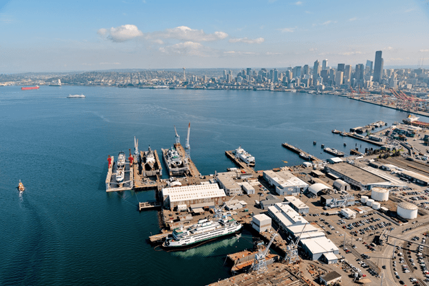 Vigor's Harbor island facility viewed on a sunny day from above. Downtown Seattle is shown in the distance.
