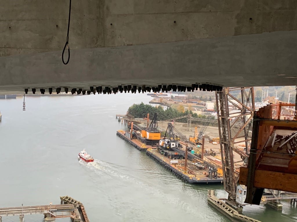 Picture of the underside of the West Seattle High Rise Bridge with Duwamish waterway below. The external post-tensioning system that we installed is located inside the girders and is not visible from outside the bridge, except for the massive anchors that are bolted through the girders and can be seen from under the bridge. 