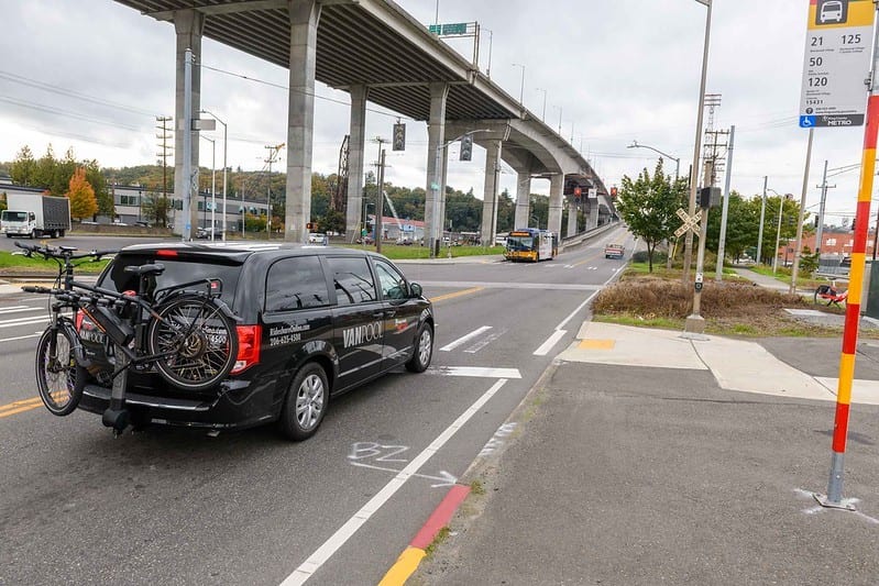 A vanpool with a bike attached to the back about to cross over the West Seattle Low Bridge.
