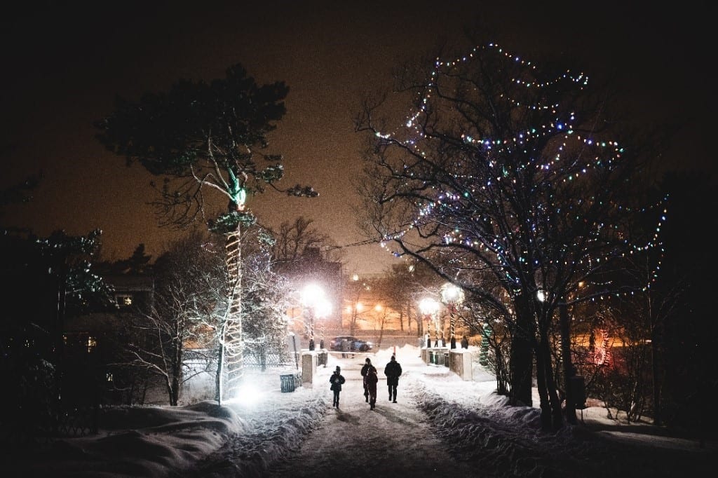 People walking at night in snow.