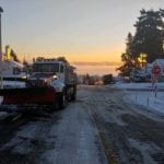 A snowplow is shown on an icy road in Seattle.