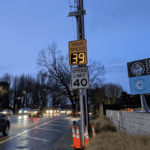 One speed radar sign is shown above a 40 mph speed limit sign. The speed radar portion shows that the vehicle is going 39 mph. The sign is located on northbound Aurora Ave N near Canlis Restaurant.
