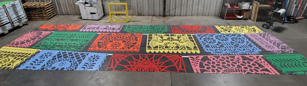 Colorful crosswalk inspired by papel picado. The crosswalk is indoors, not yet installed.