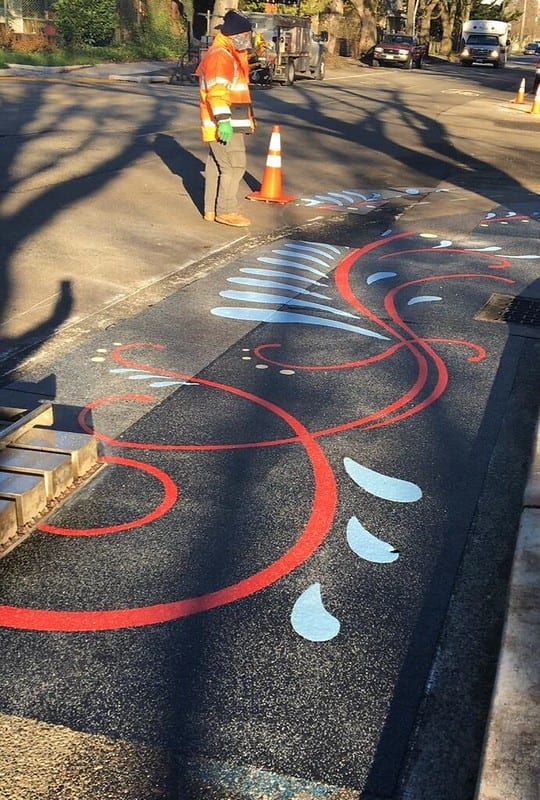Red, light blue, and dark blue design on curb bulb.