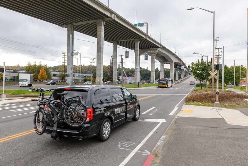 A vanpool vehicle with a bike on the back about to cross the West Seattle Low Bridge