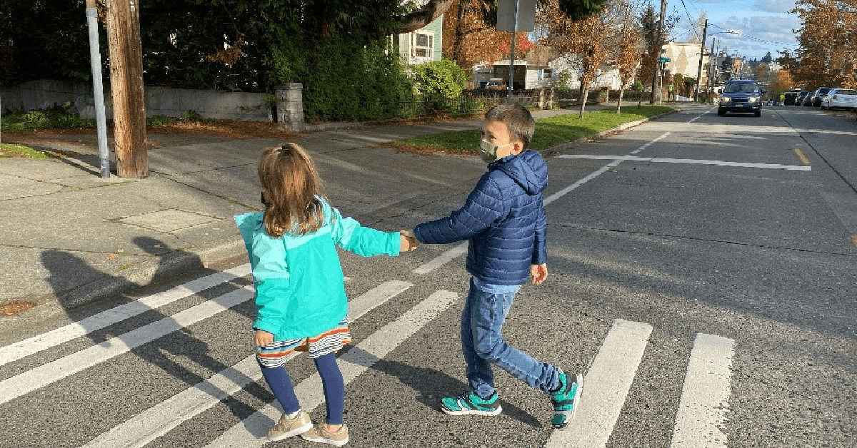 Kids holding hands crossing the street