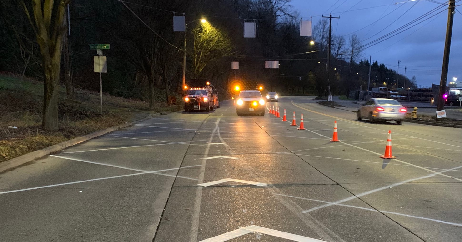 SDOT crews install cross hatchings (lane markings) near the intersection of West Marginal Way and Highland Park Way SW in West Seattle.