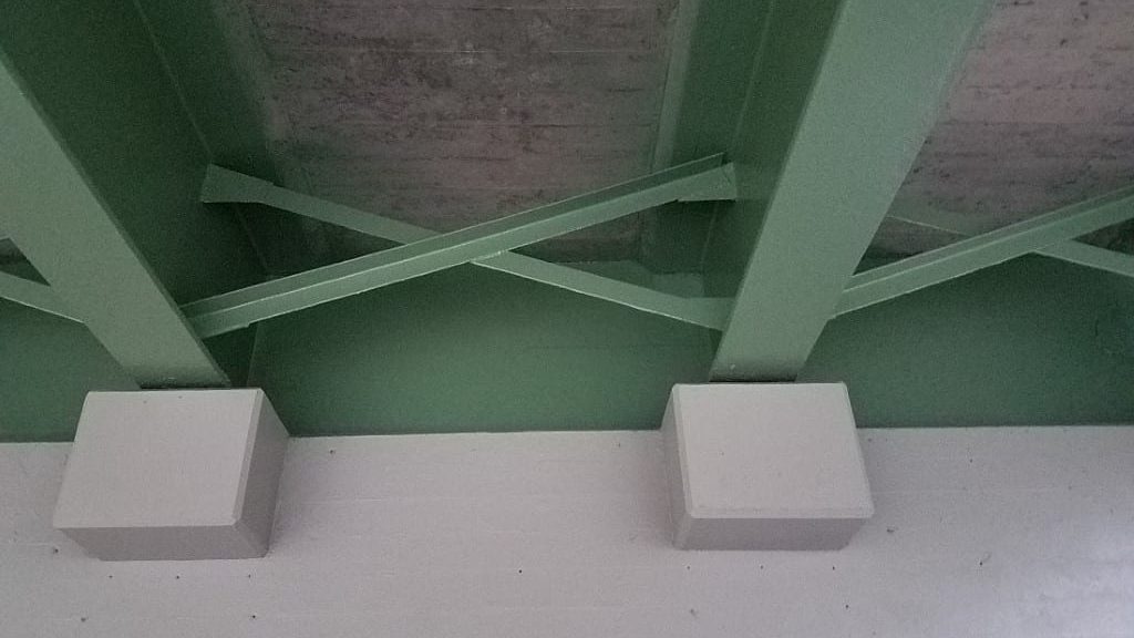 the underside of the bridge where the steel diagonal bracing connect to the steel girders that run the length of the bridge