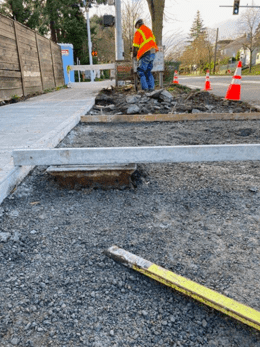 This is the form for the bus stop/ bus pad. It gets excavated, then crushed rock is added, and compacted. After checking that the forms meet the requirements for elevation, concrete was poured.