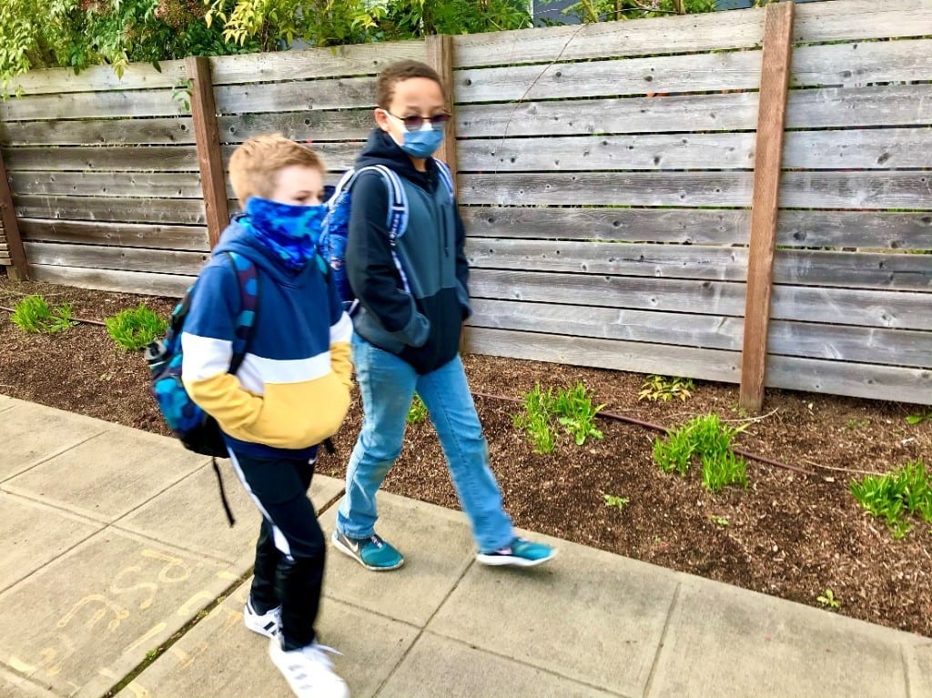 Kids walk to school with masks on