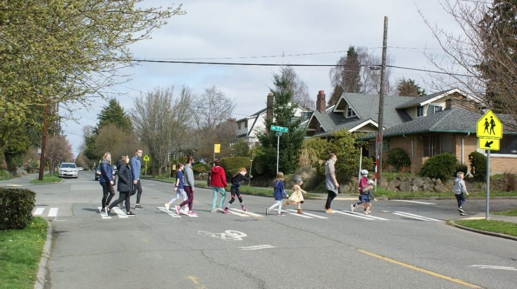 Children crossing the street on a crosswalk