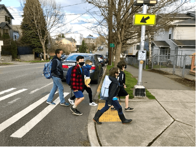 Young students crossing the street near school. 