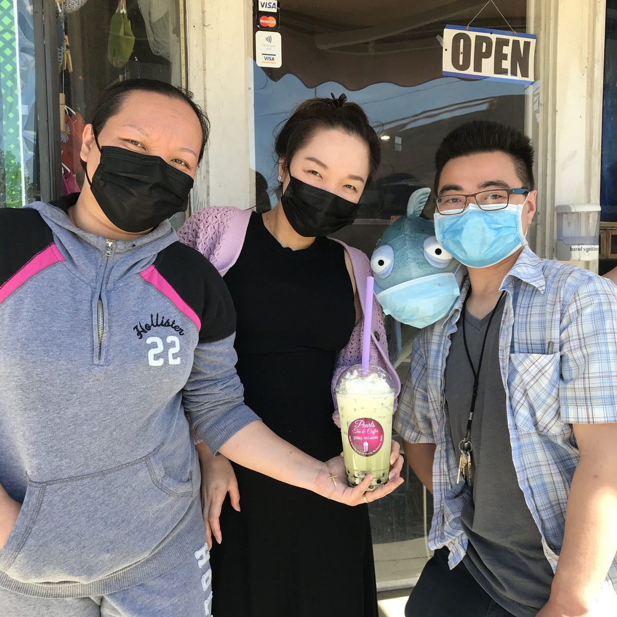 Photo of Ai, Sal the SpokesSalmon puppet, Kevin, and another friend, holding a bubble tea from Pearls Tea and Cafe