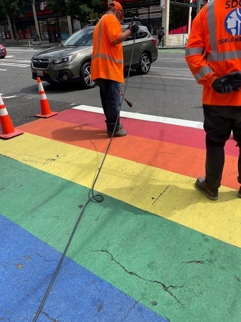 Crews re-paint a rainbow crosswalk