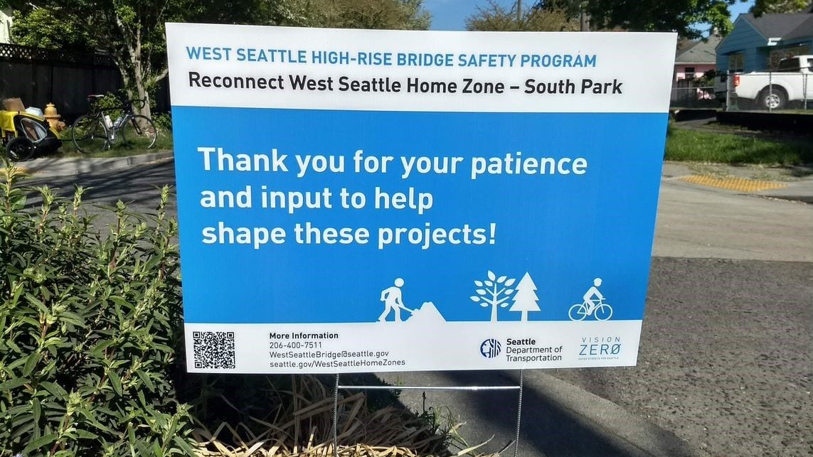 sign reading " West Seattle High-Rise Bridge Safety Program Reconnect West Seattle Home Zone - South Park. Thank you for you patience and input to help shape these projects!"