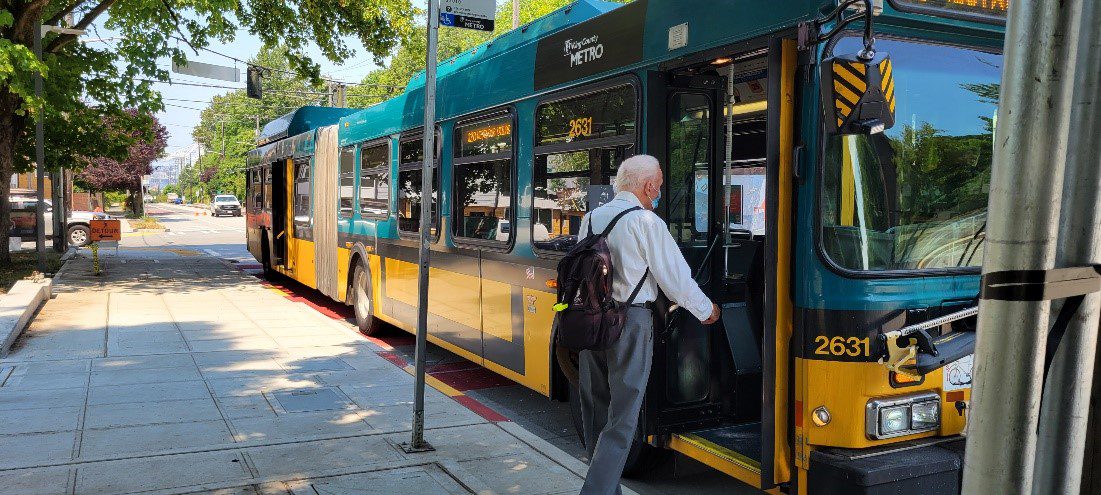 A person boards a King County Metro bus
