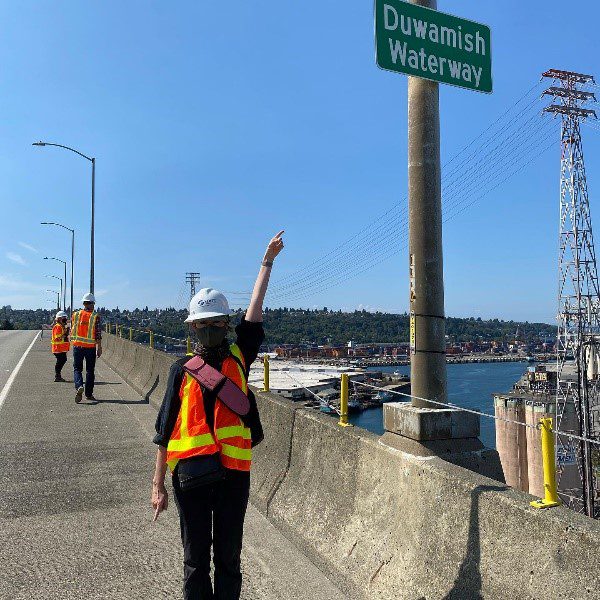 A participant points to a sign that reads "Duwamish Waterway"