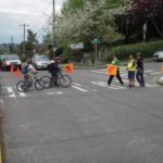 Crossing the street to school with pedestrian crossing flags. Photo Credit: SDOT.