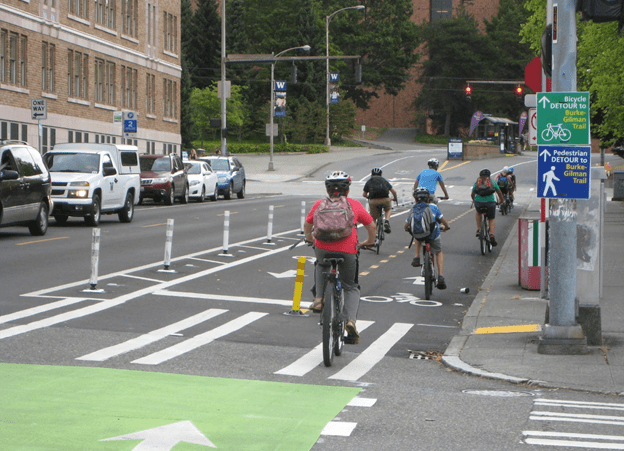 Several cyclists of all ages ride toward the University of Washington campus in Seattle. Photo Credit: SDOT Flickr.