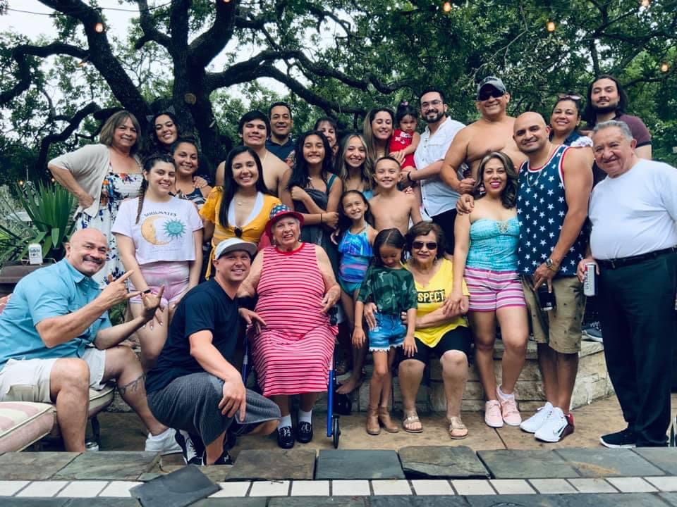 The Alinen extended family smiles for an outdoor photo at a recent family get-together. Visible are family members ranging from kids, adults and parents, and grandparents, smiling and having fun during the family event.