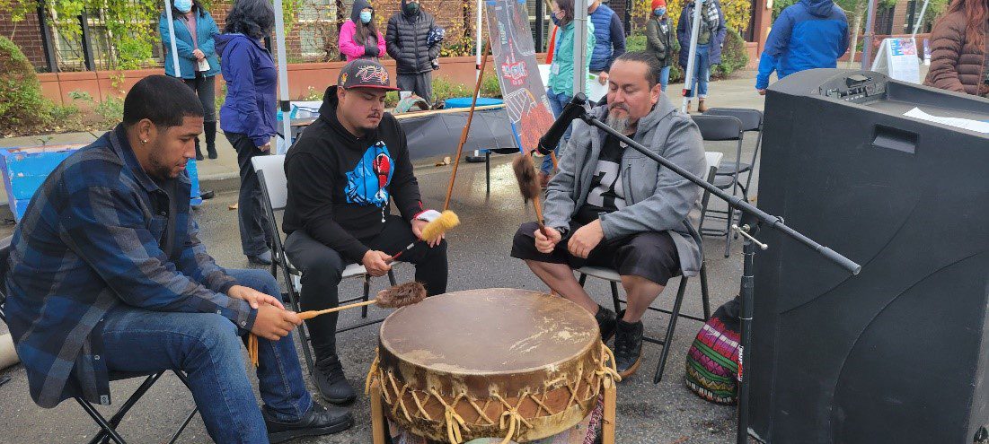 The Chief Seattle Club Drum Group performs including Derrick Belgarde, Executive Director of the Chief Seattle Club (on the right). 